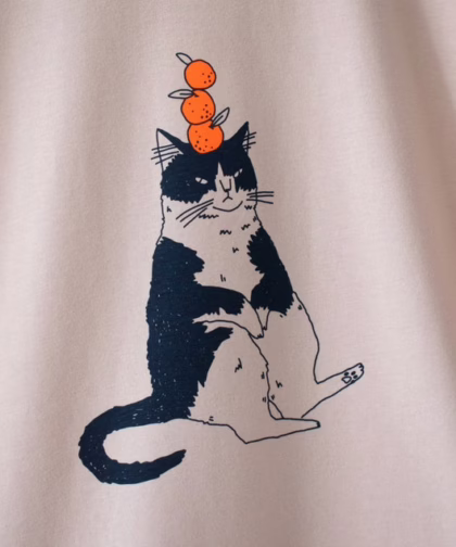 Orange Cat t-shirt | Hand screen printed illustration of a cat balancing oranges on misty pink organic cotton tee with navy and orange