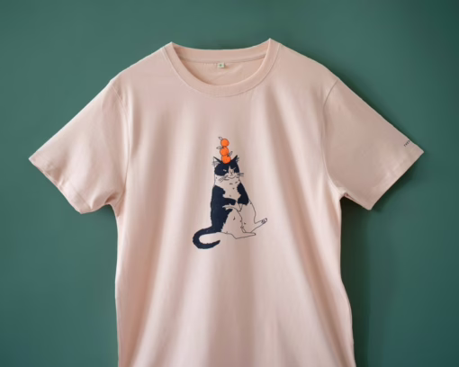 Orange Cat t-shirt | Hand screen printed illustration of a cat balancing oranges on misty pink organic cotton tee with navy and orange