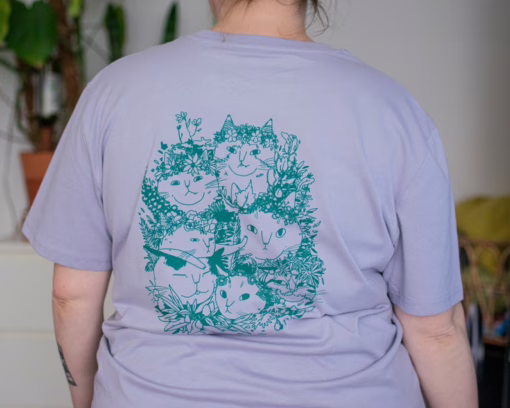 Summer Bouquet T-Shirt | Hand screen printed illustration of 7 cats with flowercrowns and other plants in green on lilac organic cotton tee