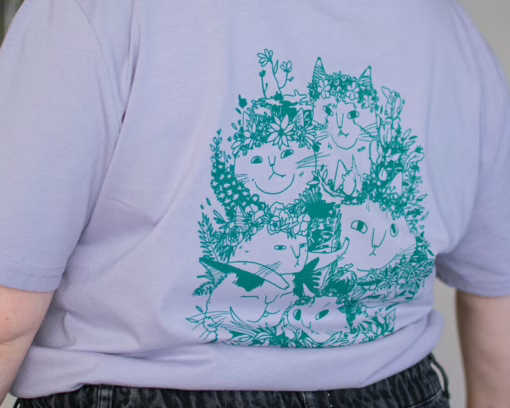 Summer Bouquet T-Shirt | Hand screen printed illustration of 7 cats with flowercrowns and other plants in green on lilac organic cotton tee